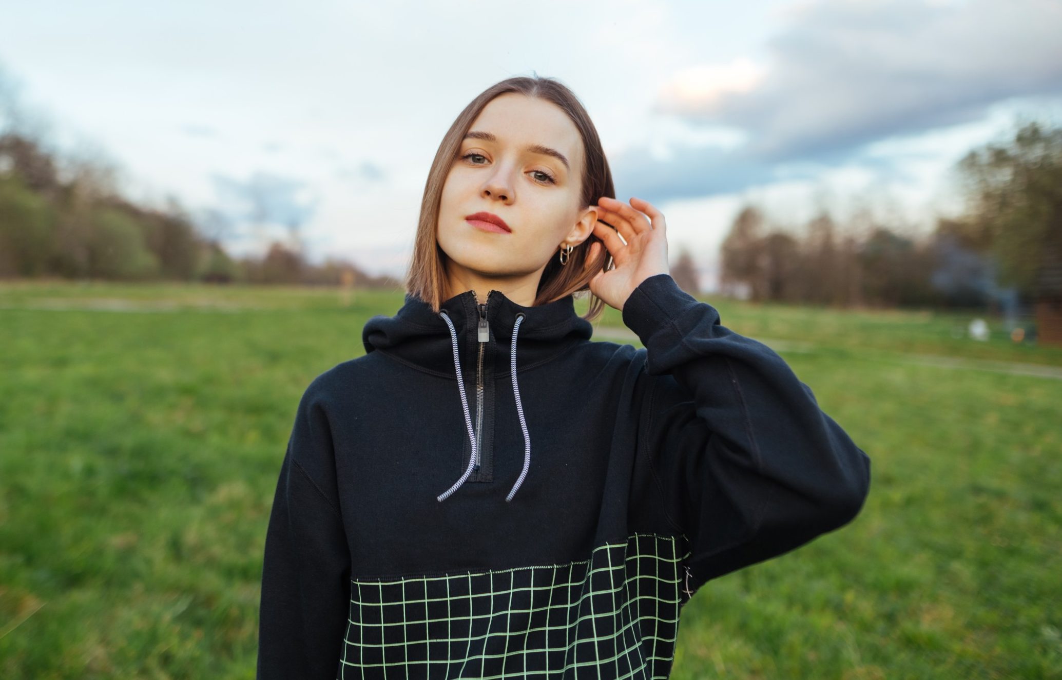 young contemplative woman standing outsite